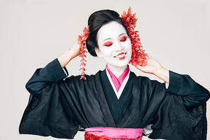 beautiful geisha in black kimono smiling isolated on white