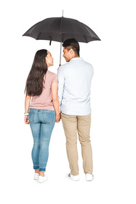 young asian couple standing under umbrella and holding hands on white background