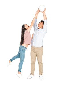 young asian man and woman playing volleyball on white background