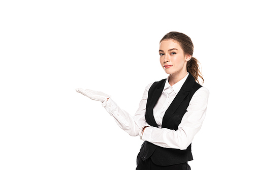 young waitress in formal wear and white gloves pointing with hand isolated on white