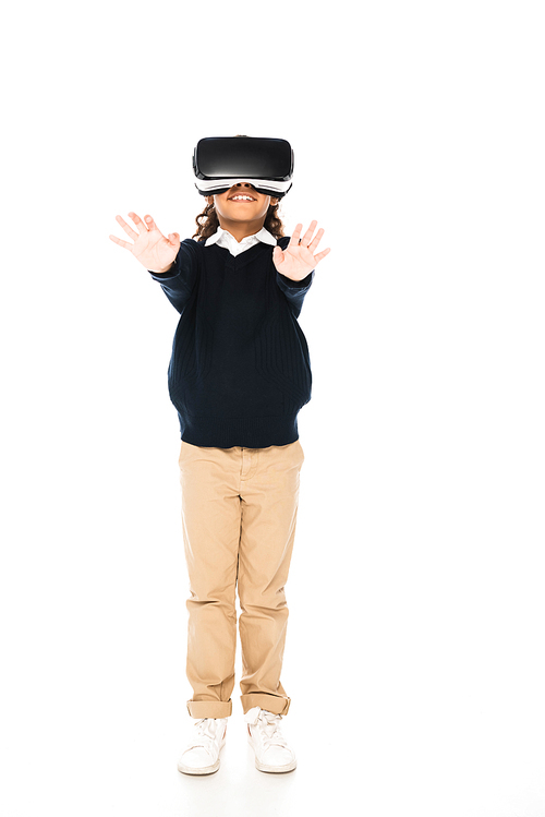 full length view of african american schoolgirls standing with outstretched hands while using virtual reality headset on white background