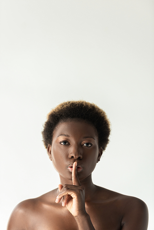 attractive nude african american girl showing silence symbol isolated on grey