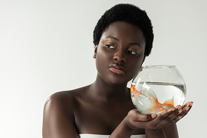 african american girl holding aquarium with fish isolated on grey