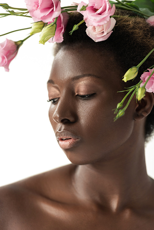 tender nude african american woman with pink eustoma flowers isolated on white