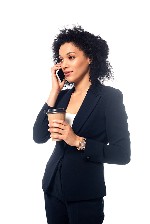 African american businesswoman talking on smartphone and holding disposable cup of coffee isolated on white