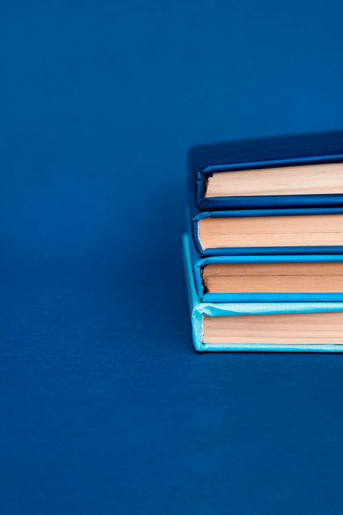 bright books on blue background with copy space