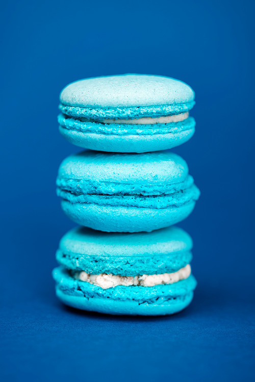 sweet and tasty french macaroons on blue background
