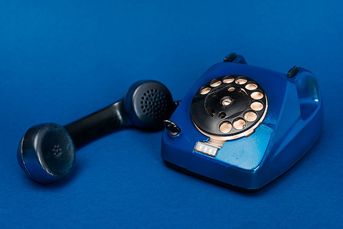 retro telephone on blue background with copy space