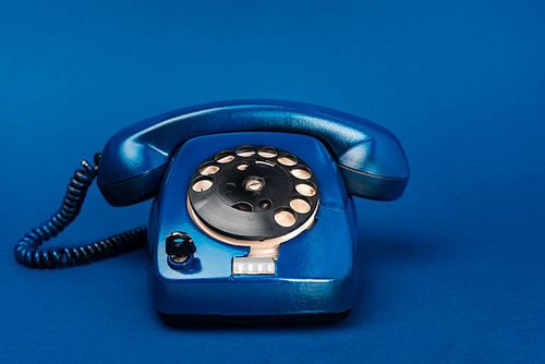 bright and colorful retro telephone on blue background