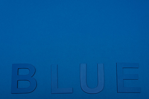 top view of blue lettering isolated on blue