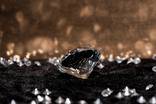 Selective focus of diamond and gemstones on velvet surface with reflection