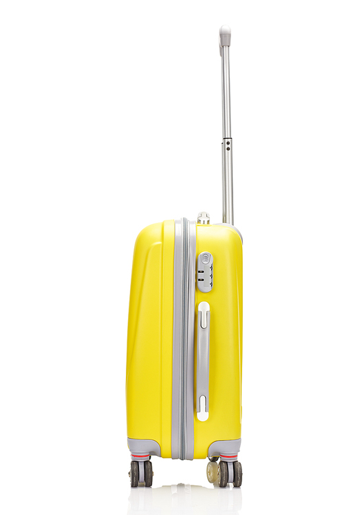 side view of yellow plastic wheeled colorful suitcase with handle isolated on white