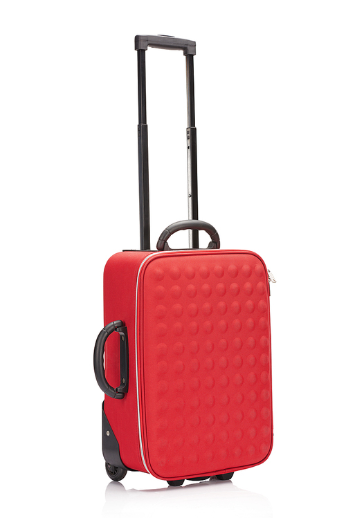 red textured colorful suitcase with handle on wheels isolated on white