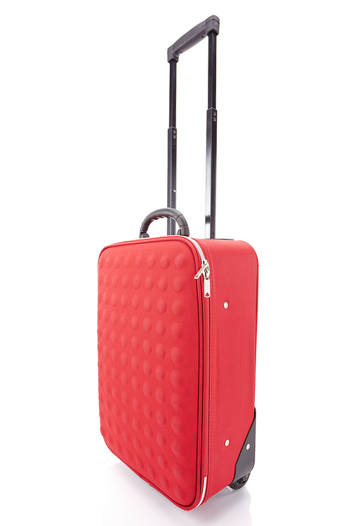 red wheeled textured colorful suitcase with handle isolated on white