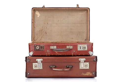 two vintage brown leather suitcases with one opened isolated on white