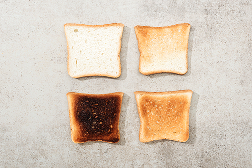 Top view of bread toasts on grey textured surface