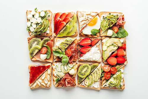 top view of toasts with fresh fruits and s isolated on white