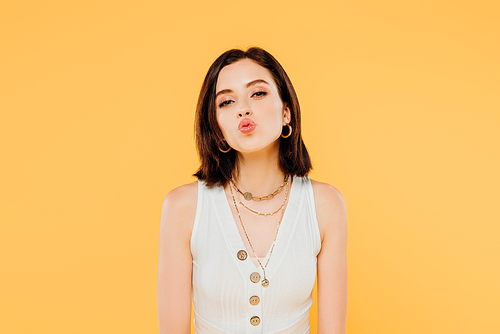 elegant girl pouting lips isolated on yellow