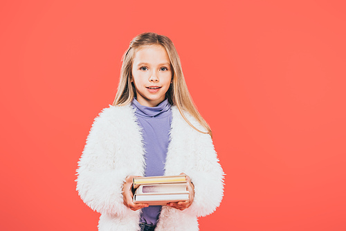 front view of kid holding books isolated on red