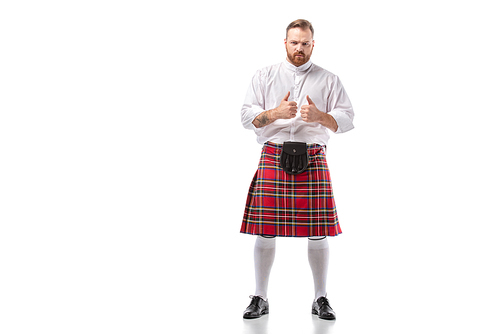 Scottish redhead bearded man in red tartan kilt showing thumbs up on white background
