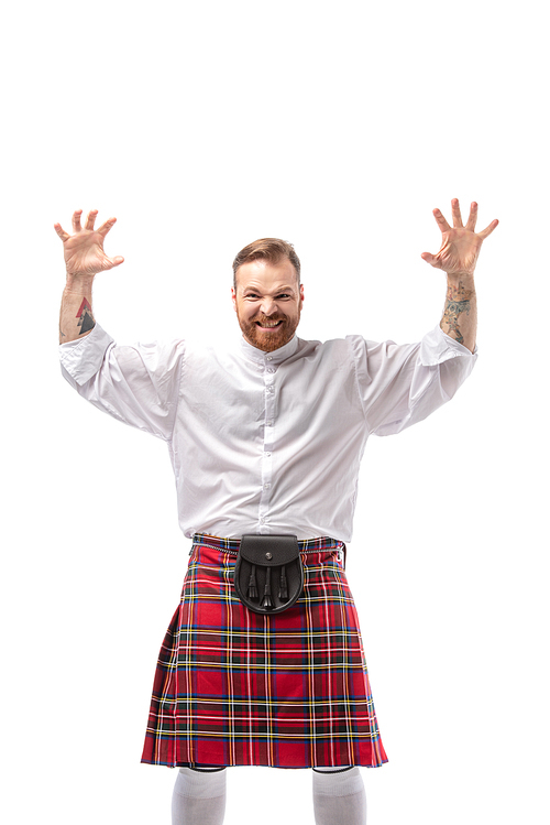 Scottish redhead man in red kilt scaring isolated on white