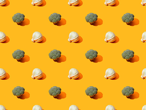 fresh green broccoli and cabbage on orange background, seamless pattern