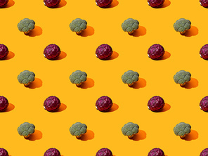 fresh green broccoli and red cabbage on orange background, seamless pattern