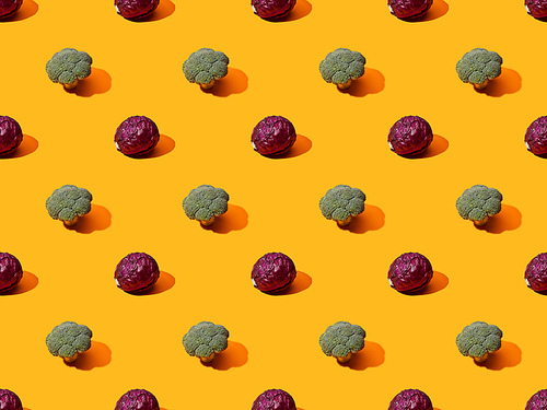 fresh green broccoli and red cabbage on orange background, seamless pattern