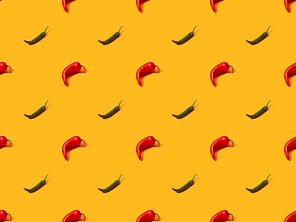 red spicy chili peppers and jalapenos on orange colorful background, seamless pattern