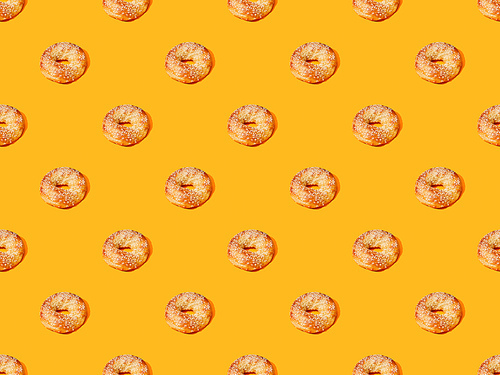 fresh buns on orange colorful background, seamless pattern