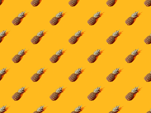 whole ripe pineapple on orange colorful background, seamless pattern