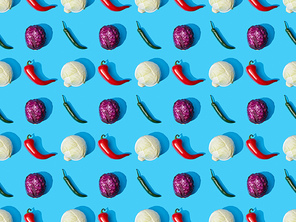 top view of whole ripe cabbage and peppers on blue background, seamless pattern