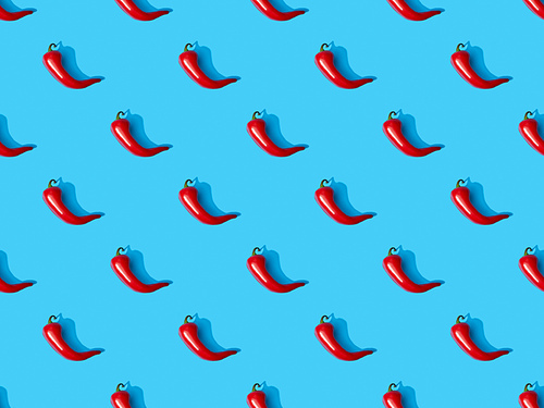 top view of red spicy chili peppers on blue colorful background, seamless pattern
