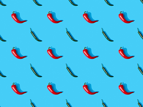 top view of red spicy chili peppers and jalapenos on blue colorful background, seamless pattern