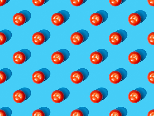 top view of fresh tomatoes on blue colorful background, seamless pattern