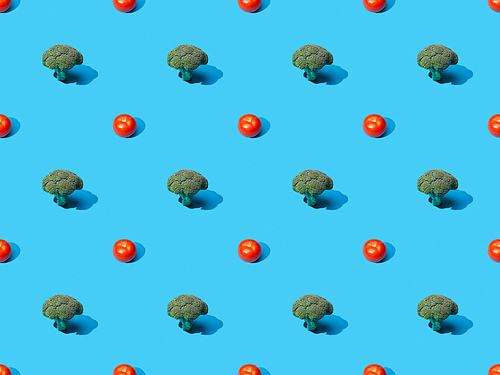 fresh green broccoli and tomatoes on blue background, seamless pattern