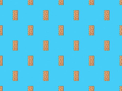 top view of fresh crispbread on blue colorful background, seamless pattern