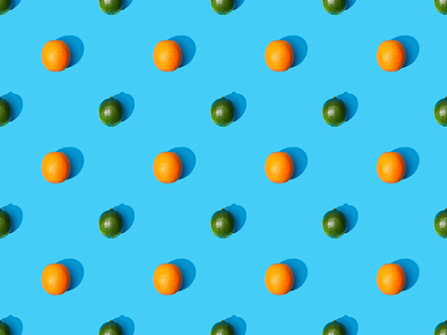top view of ripe oranges and limes on blue colorful background, seamless pattern