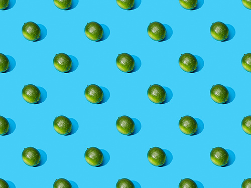 fresh whole limes on blue colorful background, seamless pattern