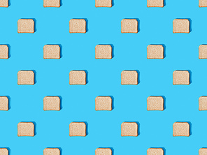 top view of fresh toast bread on blue colorful background, seamless pattern