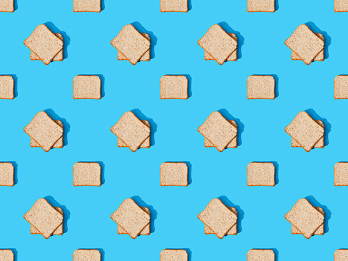 top view of fresh toast bread on blue colorful background, seamless pattern