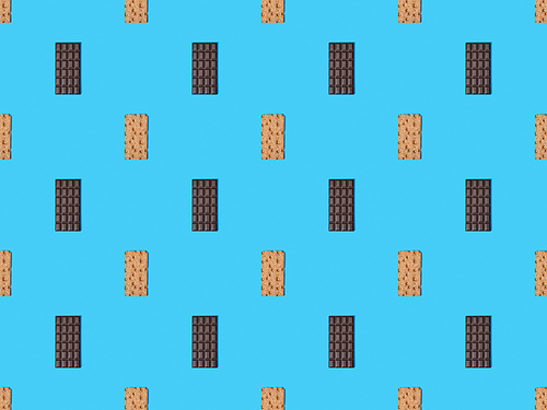 top view of sweet dark chocolate bars and crispbread on blue colorful background, seamless pattern