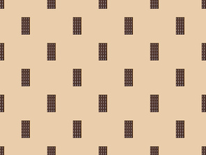 top view of sweet dark chocolate bars on beige background, seamless pattern