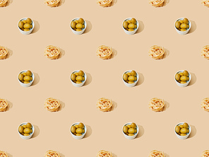 fresh pasta with olives on beige background, seamless pattern