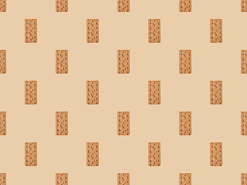 top view of fresh crispbread on beige background, seamless pattern