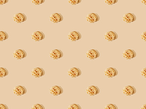 top view of fresh Tagliatelle on beige background, seamless pattern