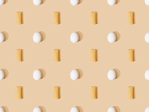 top view of fresh cannelloni with eggs on beige background, seamless pattern