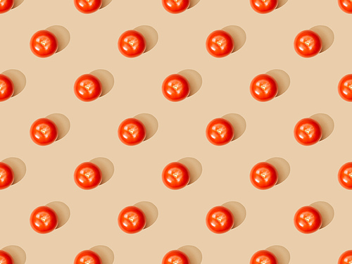top view of ripe fresh tomatoes on beige background, seamless pattern