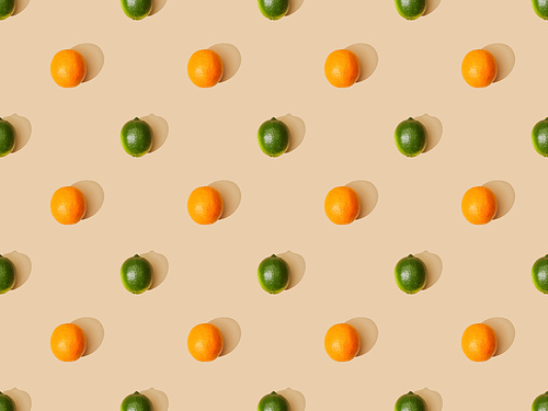 top view of ripe oranges and limes on beige background, seamless pattern