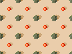 top view of fresh green broccoli and tomatoes on beige background, seamless pattern